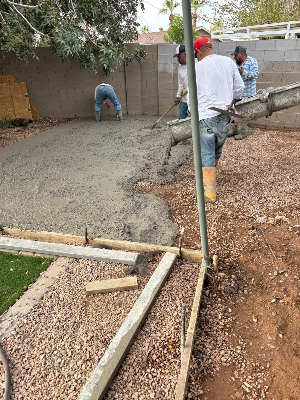 Crew placing and finishing fresh concrete